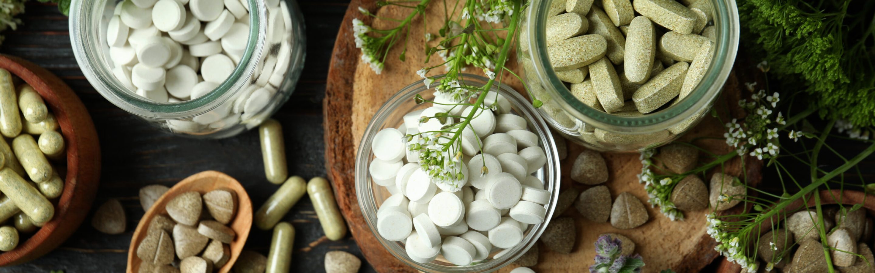 Concept of herbal medicine pills on wooden table, top view Concept of herbal medicine pills on wooden table, top view